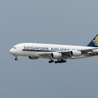 Singapore Airlines aircraft flying in grey sky