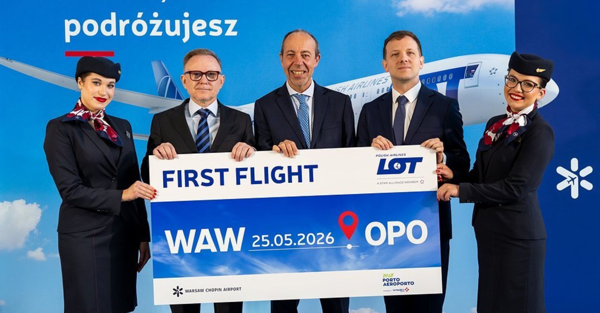 LOT Polish Airlines crew holding a Warsaw to Porto first flight sign