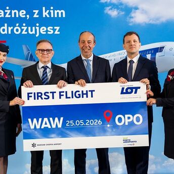 LOT Polish Airlines crew holding a Warsaw to Porto first flight sign