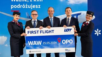 LOT Polish Airlines crew holding a Warsaw to Porto first flight sign