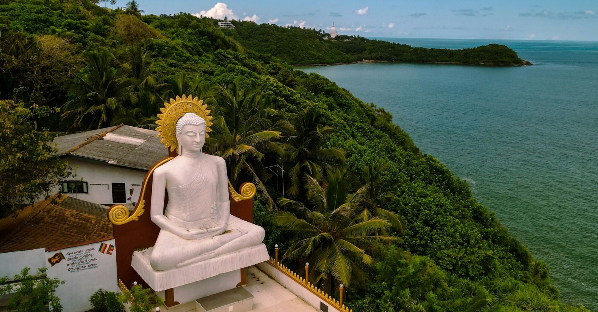 Large Buddha statue overlooking Sri Lanka’s green coastline