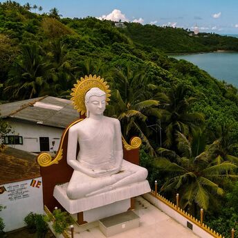 Large Buddha statue overlooking Sri Lanka’s green coastline
