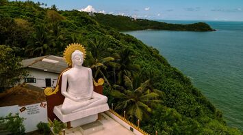 Large Buddha statue overlooking Sri Lanka’s green coastline