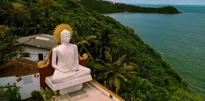 Large Buddha statue overlooking Sri Lanka’s green coastline