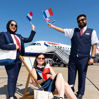 British Airways Cityflyer staff holding French flags beside an aircraft at London City Airport