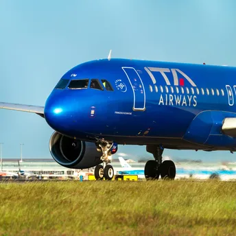 ITA Airways aircraft on runway at airport