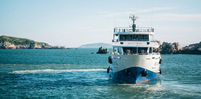Ferry sailing across open blue water