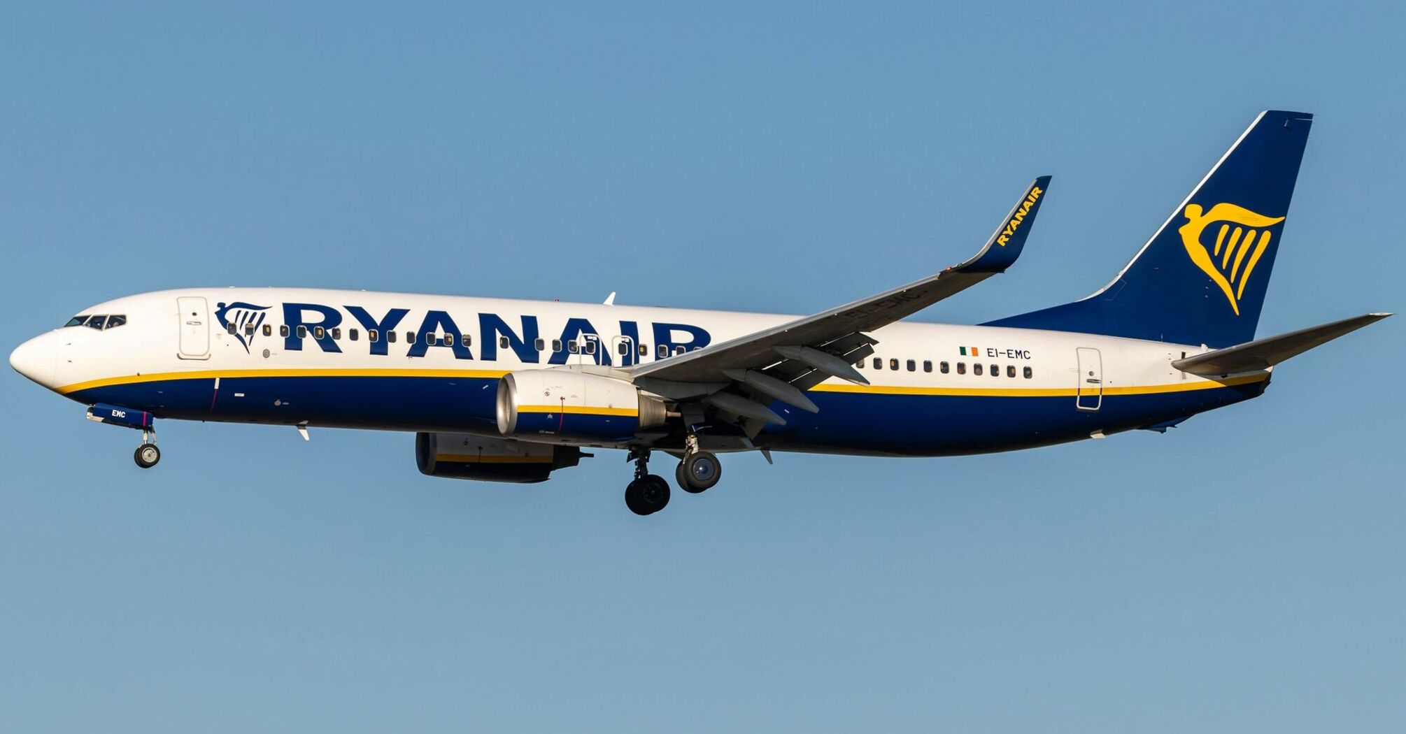 Ryanair aircraft flying against a clear blue sky