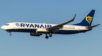 Ryanair aircraft flying against a clear blue sky