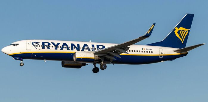 Ryanair aircraft flying against a clear blue sky