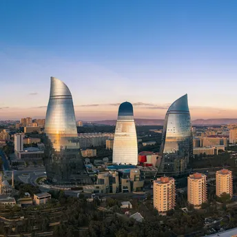 Flame Towers rising above Baku city at sunset