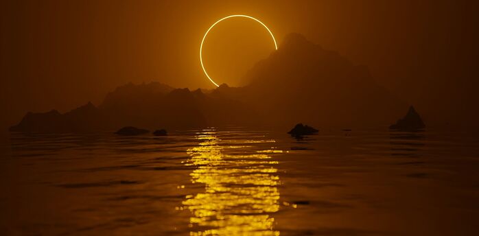 Solar eclipse glowing above the sea and distant mountains