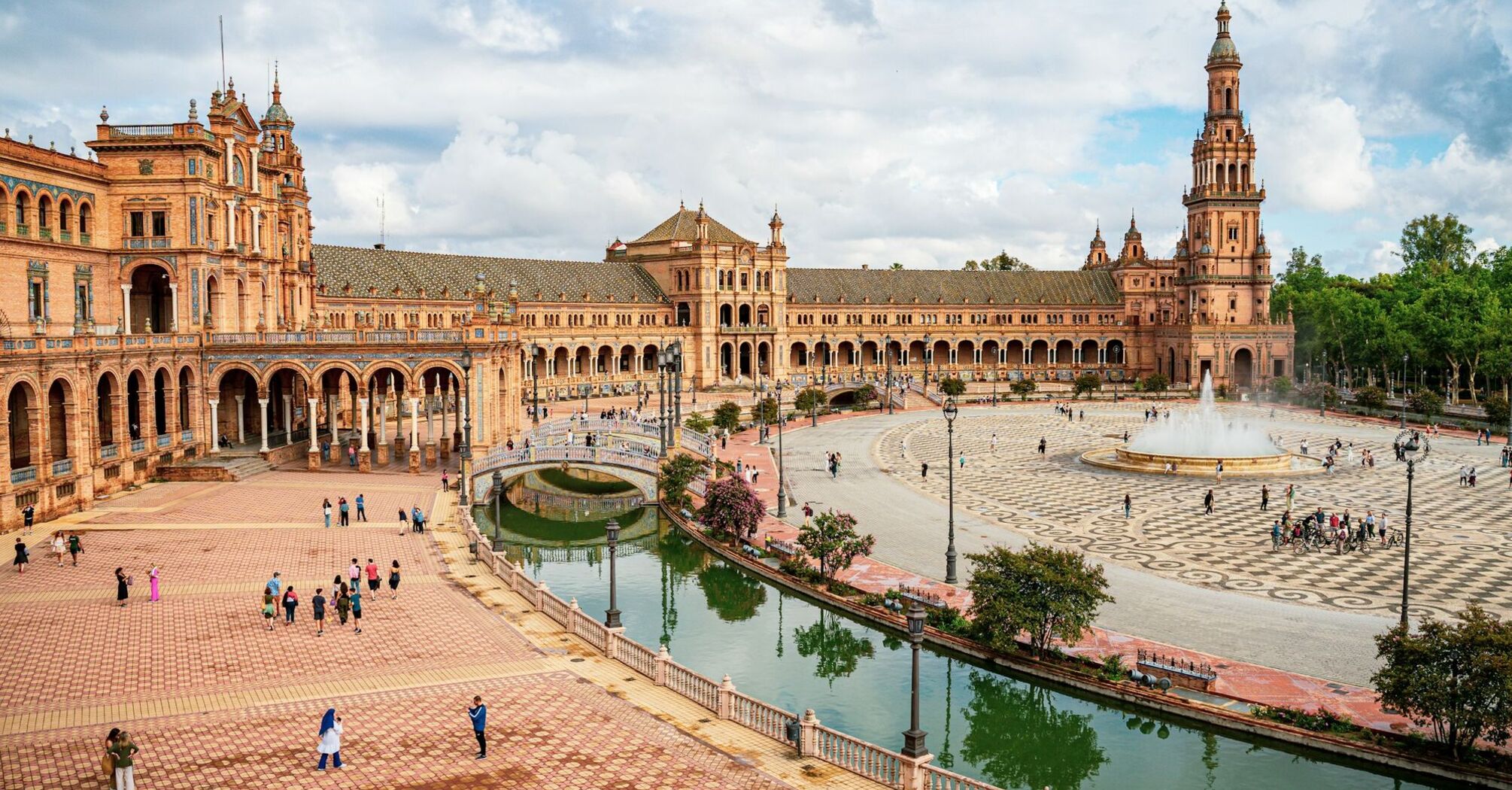 Plaza de España in Seville with historic buildings, canal and fountain
