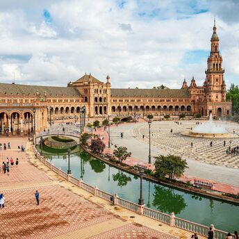 Plaza de España in Seville with historic buildings, canal and fountain