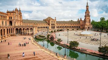 Plaza de España in Seville with historic buildings, canal and fountain