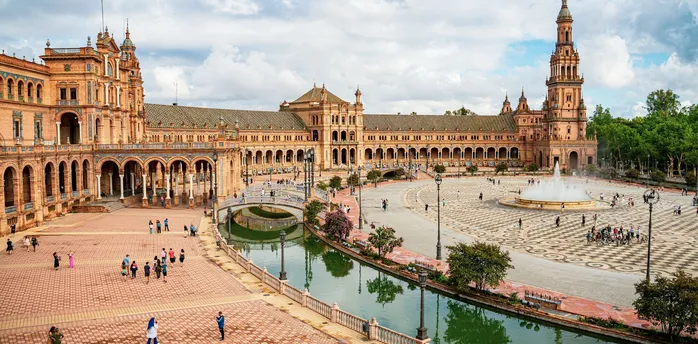 Plaza de España in Seville with historic buildings, canal and fountain