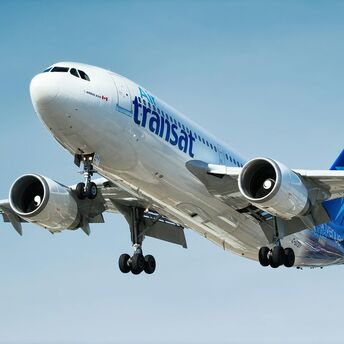 Air Transat aircraft flying against a blue sky