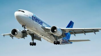 Air Transat aircraft flying against a blue sky