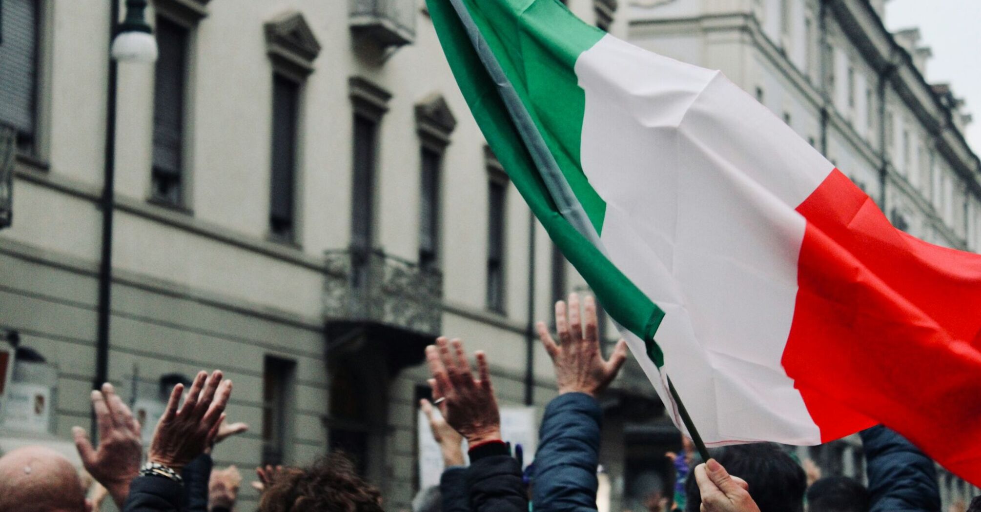Italian flag raised during a public protest in Italy