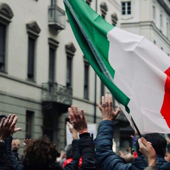 Italian flag raised during a public protest in Italy