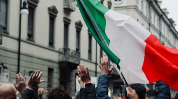 Italian flag raised during a public protest in Italy