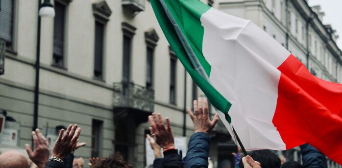 Italian flag raised during a public protest in Italy