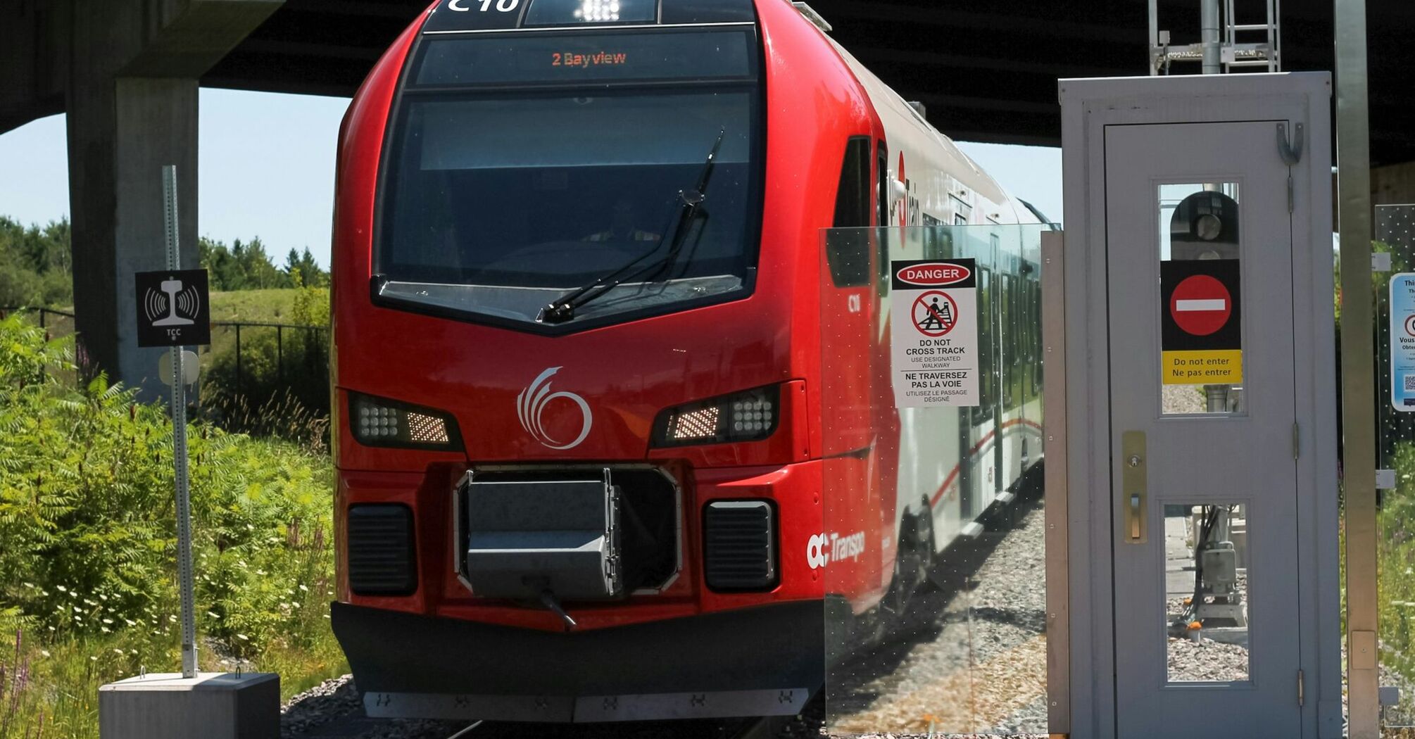 Red passenger train stopped at a station platform
