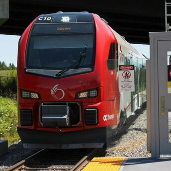Red passenger train stopped at a station platform