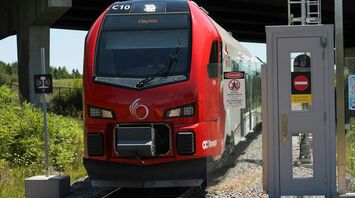 Red passenger train stopped at a station platform