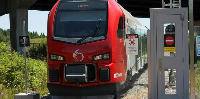 Red passenger train stopped at a station platform