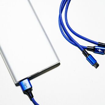 Portable power bank with multiple charging cables on a white background