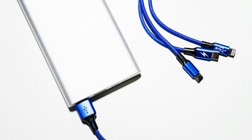 Portable power bank with multiple charging cables on a white background