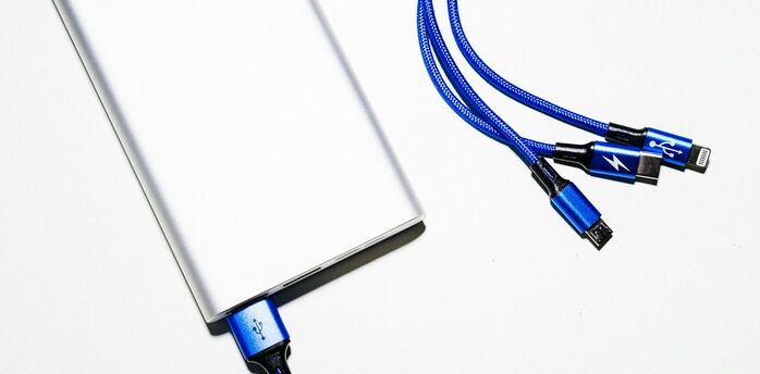 Portable power bank with multiple charging cables on a white background