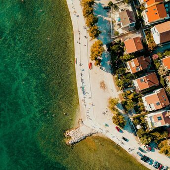 Aerial view of Zadar’s coastline with clear Adriatic water and seaside homes