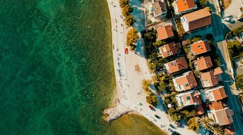 Aerial view of Zadar’s coastline with clear Adriatic water and seaside homes