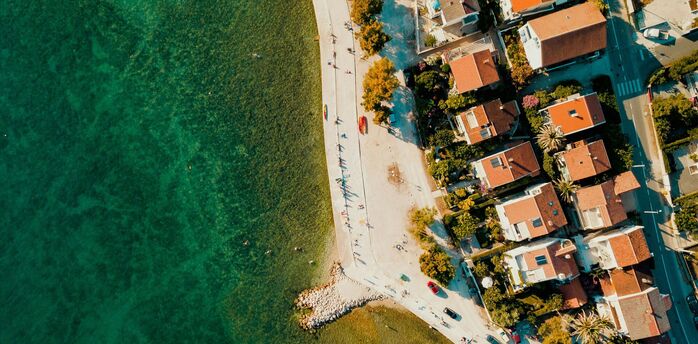 Aerial view of Zadar’s coastline with clear Adriatic water and seaside homes