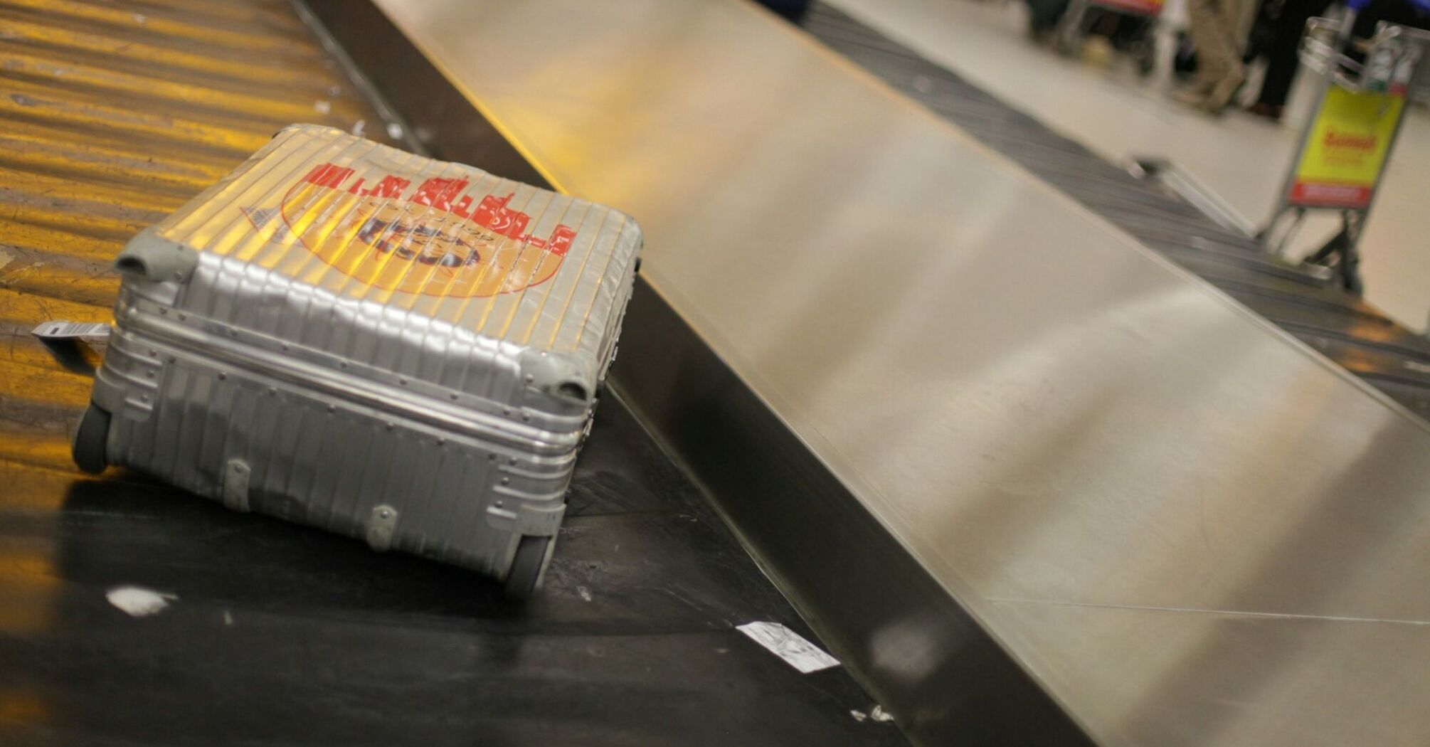 Silver suitcase on an airport baggage carousel