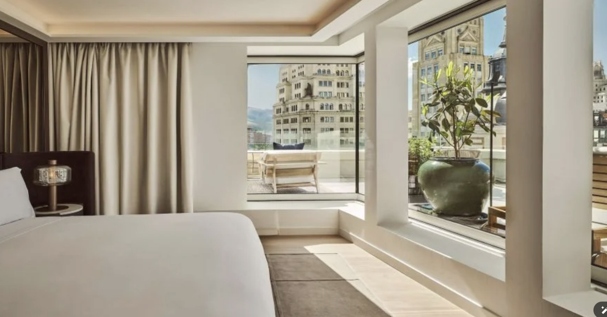 Guest room at Nobu Hotel Madrid with large windows and city views
