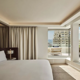 Guest room at Nobu Hotel Madrid with large windows and city views