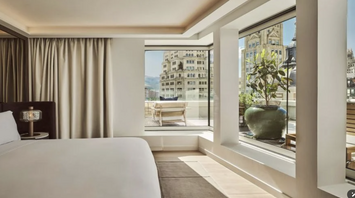 Guest room at Nobu Hotel Madrid with large windows and city views