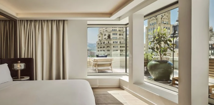 Guest room at Nobu Hotel Madrid with large windows and city views