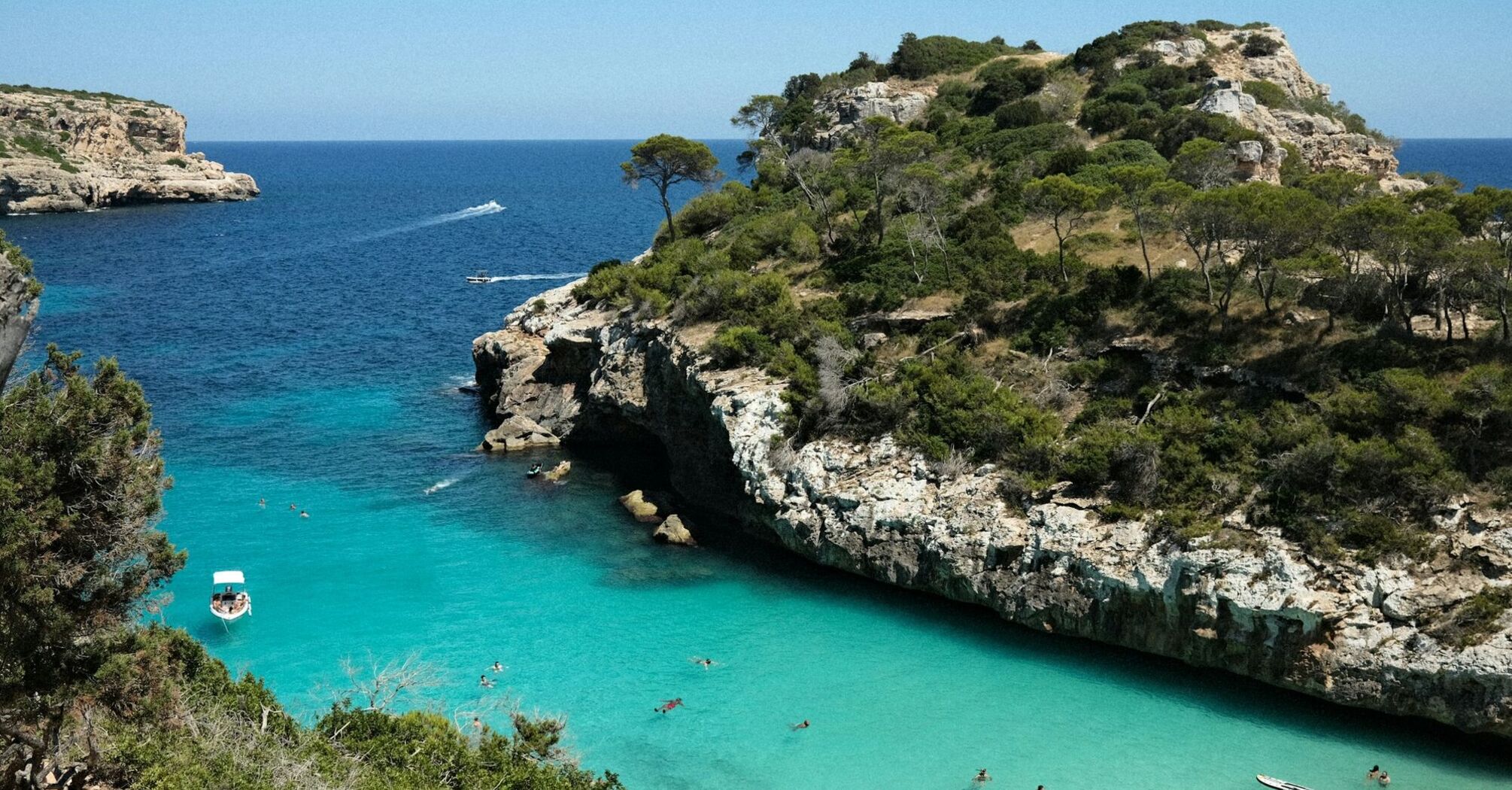Turquoise cove with swimmers on Mallorca coast