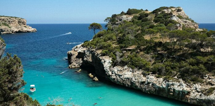 Turquoise cove with swimmers on Mallorca coast