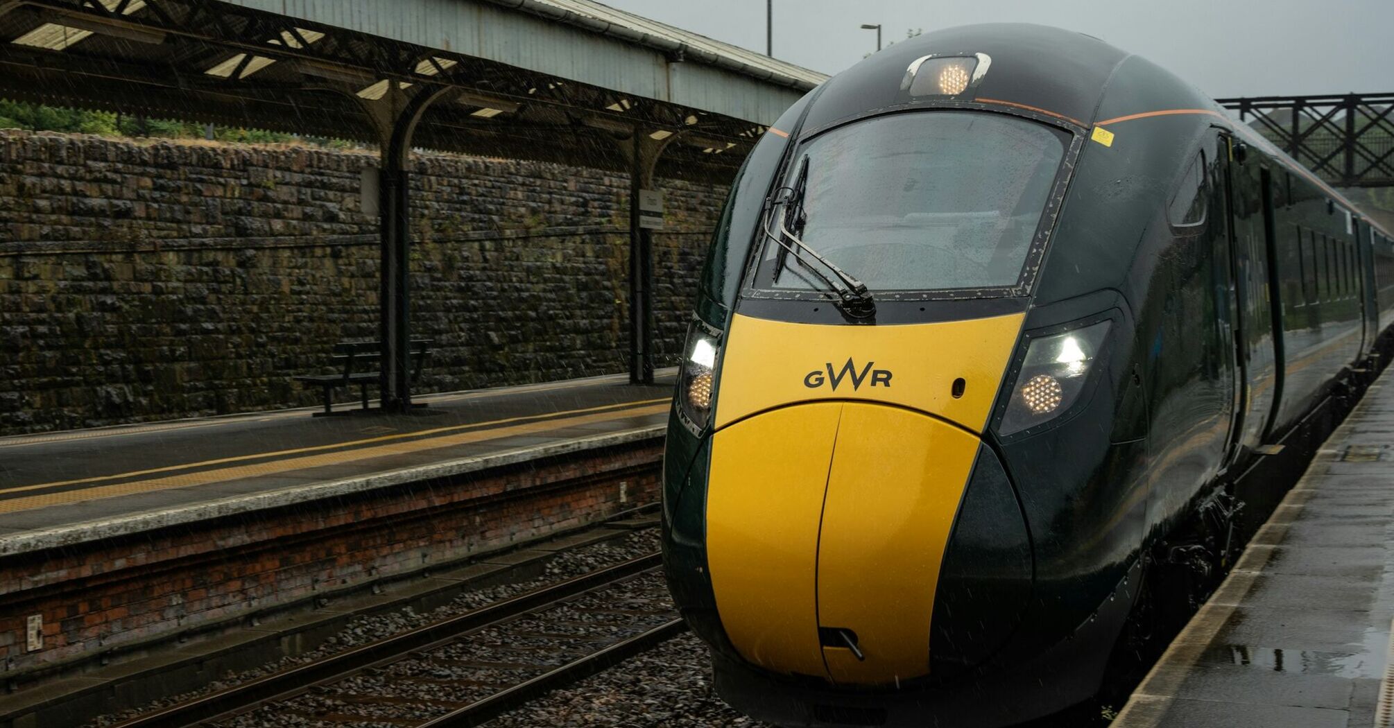 GWR train at a railway station in the rain