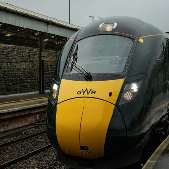 GWR train at a railway station in the rain