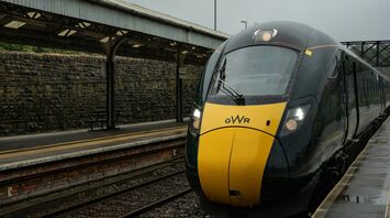 GWR train at a railway station in the rain