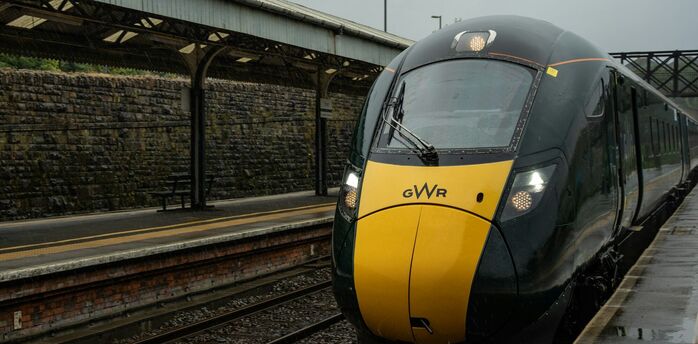 GWR train at a railway station in the rain