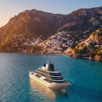 Four Seasons luxury yacht sailing along a coastal cliffside