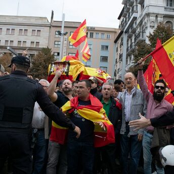 Protesters with Spanish flags near police officers