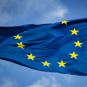 EU flag waving against a blue sky